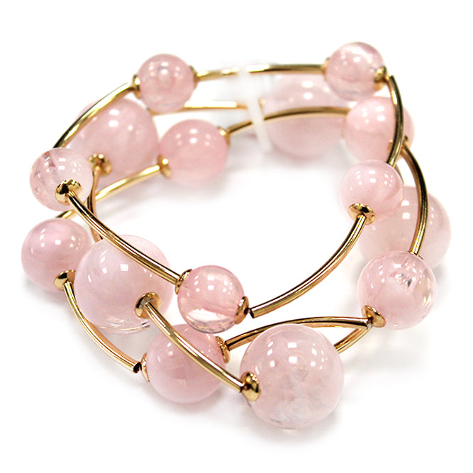 Multi strand acrylic bead coil bracelet with glossy round beads and gold wire accents in soft pink