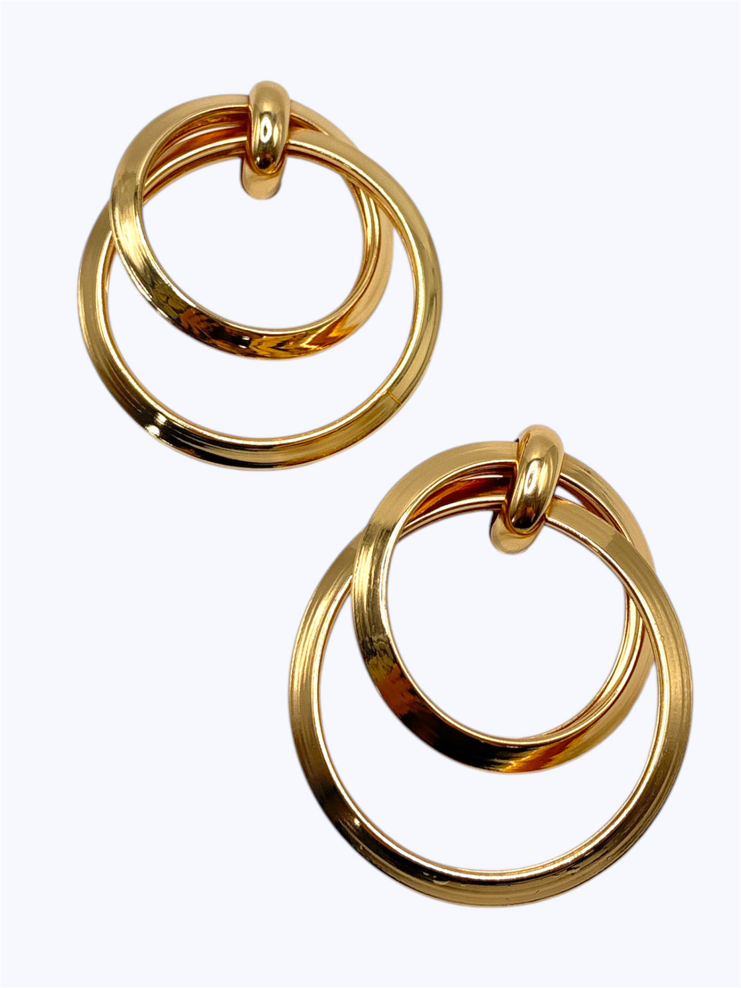 Pair of gold hoop earrings on a white background