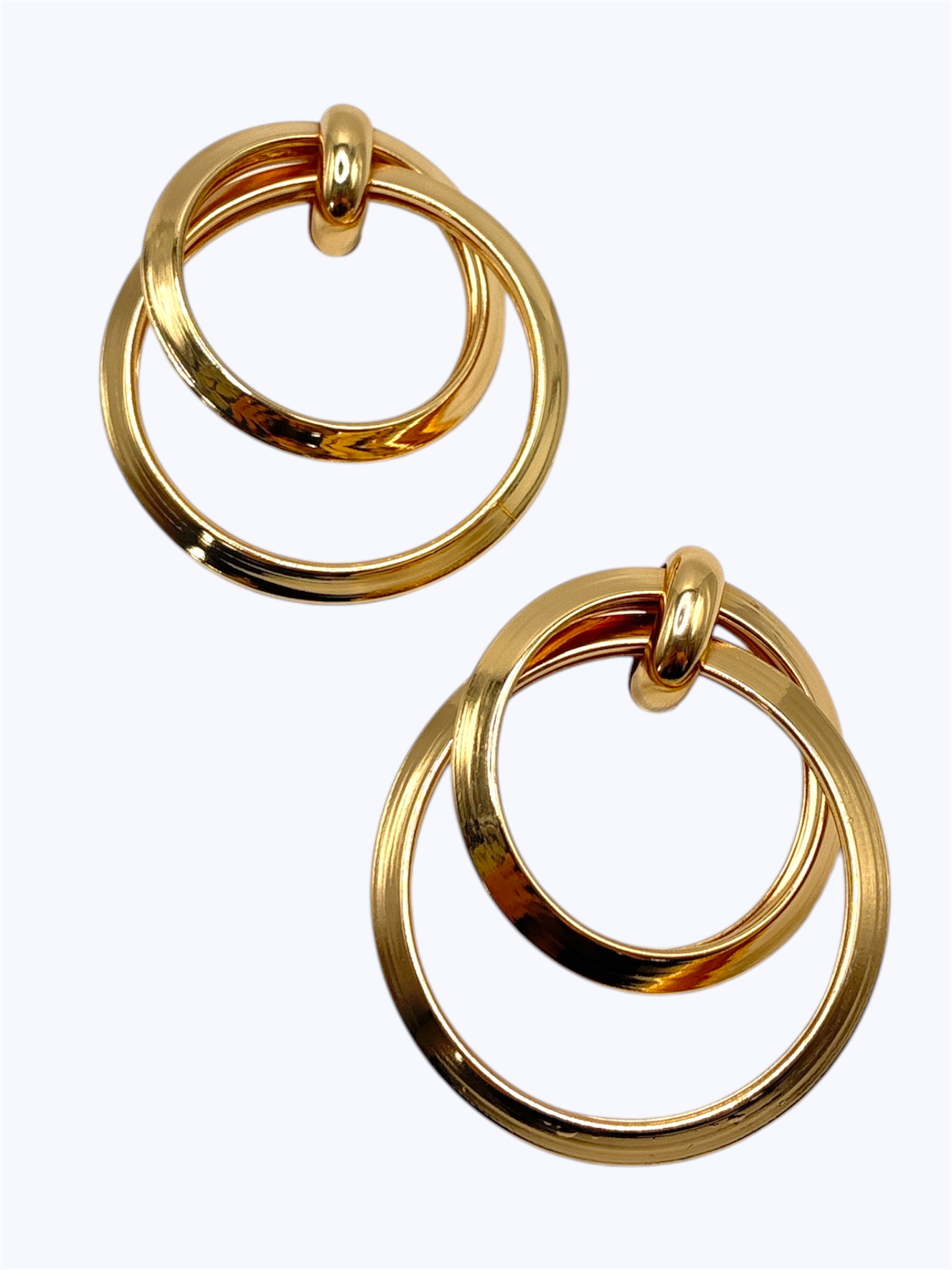 Pair of gold hoop earrings on a white background