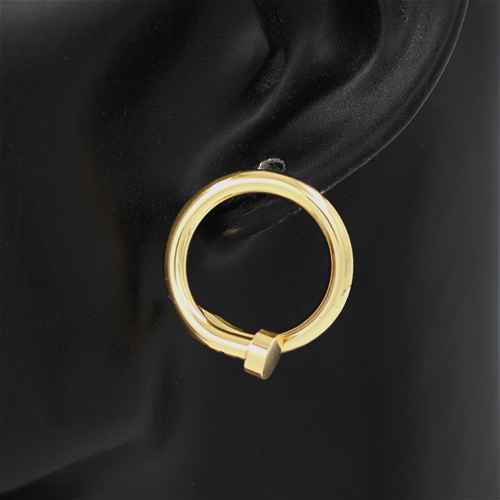 Gold hoop earring on a black earlobe