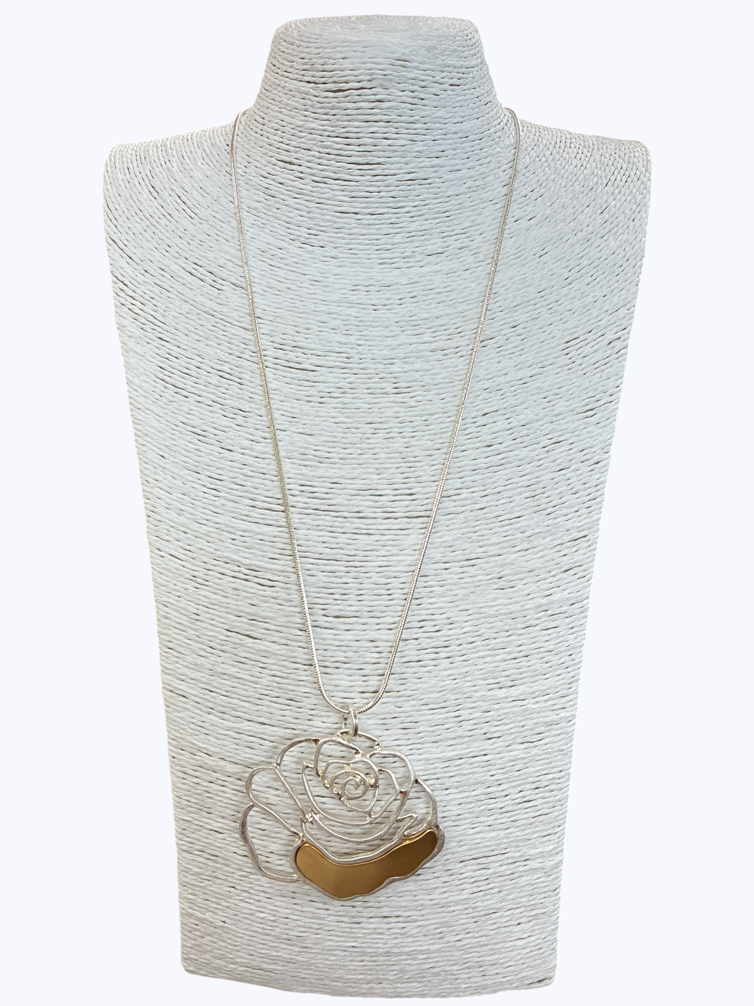 Necklace with a floral pendant on a textured gray stand against a white background