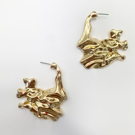 A pair of gold-colored metal earrings designed in a vintage bohemian style.