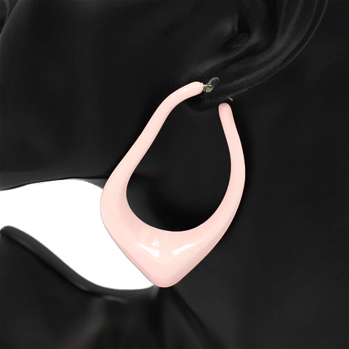 Oversized sculptural hoop earrings with abstract curved teardrop shape and glossy finish