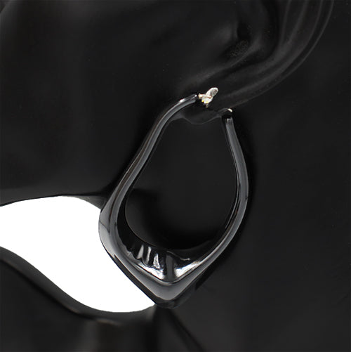Oversized sculptural hoop earrings with abstract curved teardrop shape and glossy finish