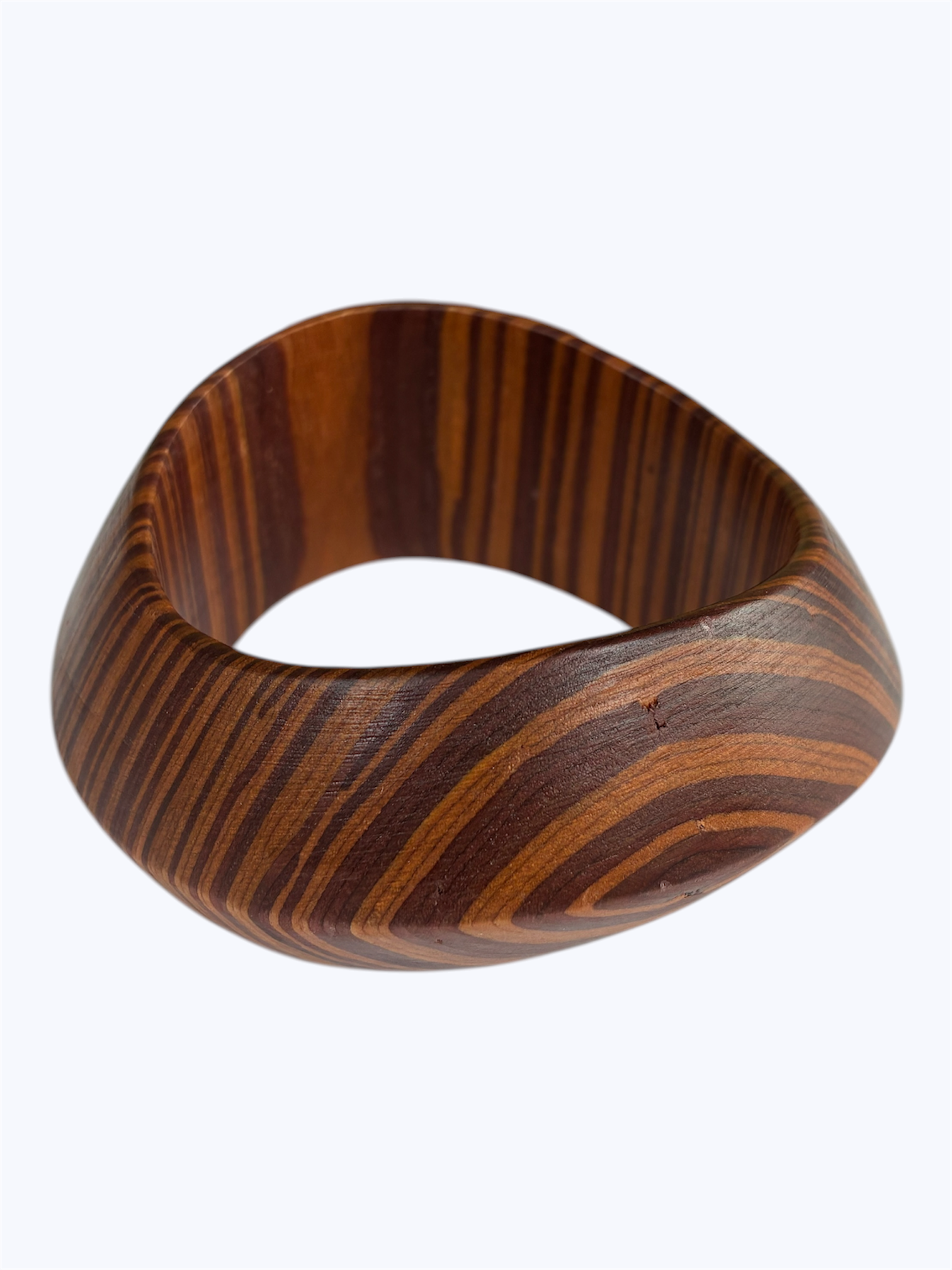 Brown wood grain sculpted bangle bracelet with an organic curved silhouette and modern minimalist style