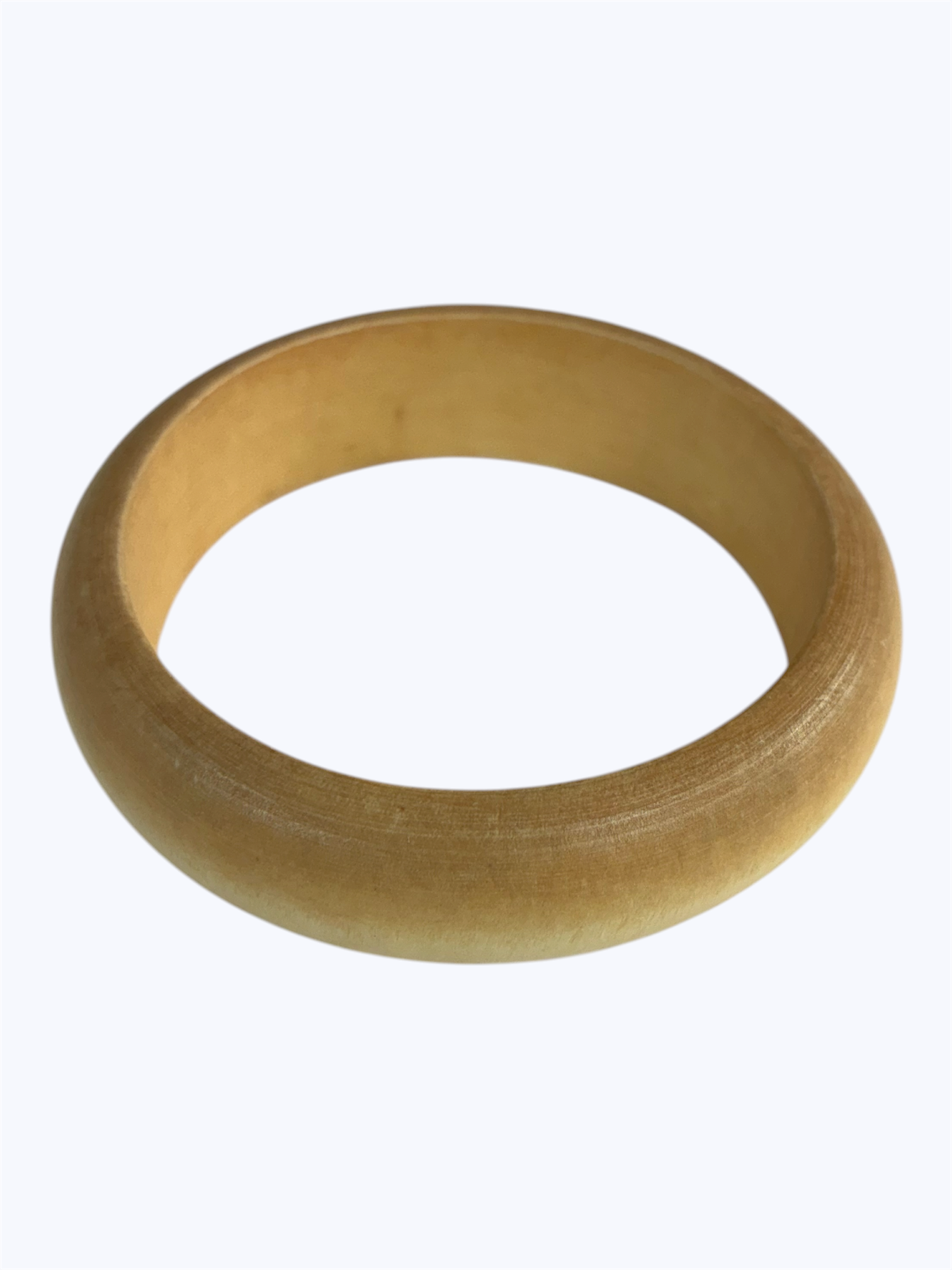 Natural wood bangle bracelet with a smooth rounded silhouette and minimalist artisan style