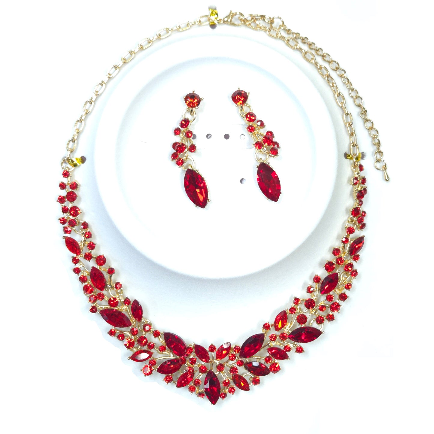 Jewelry set with red gemstones on a white background