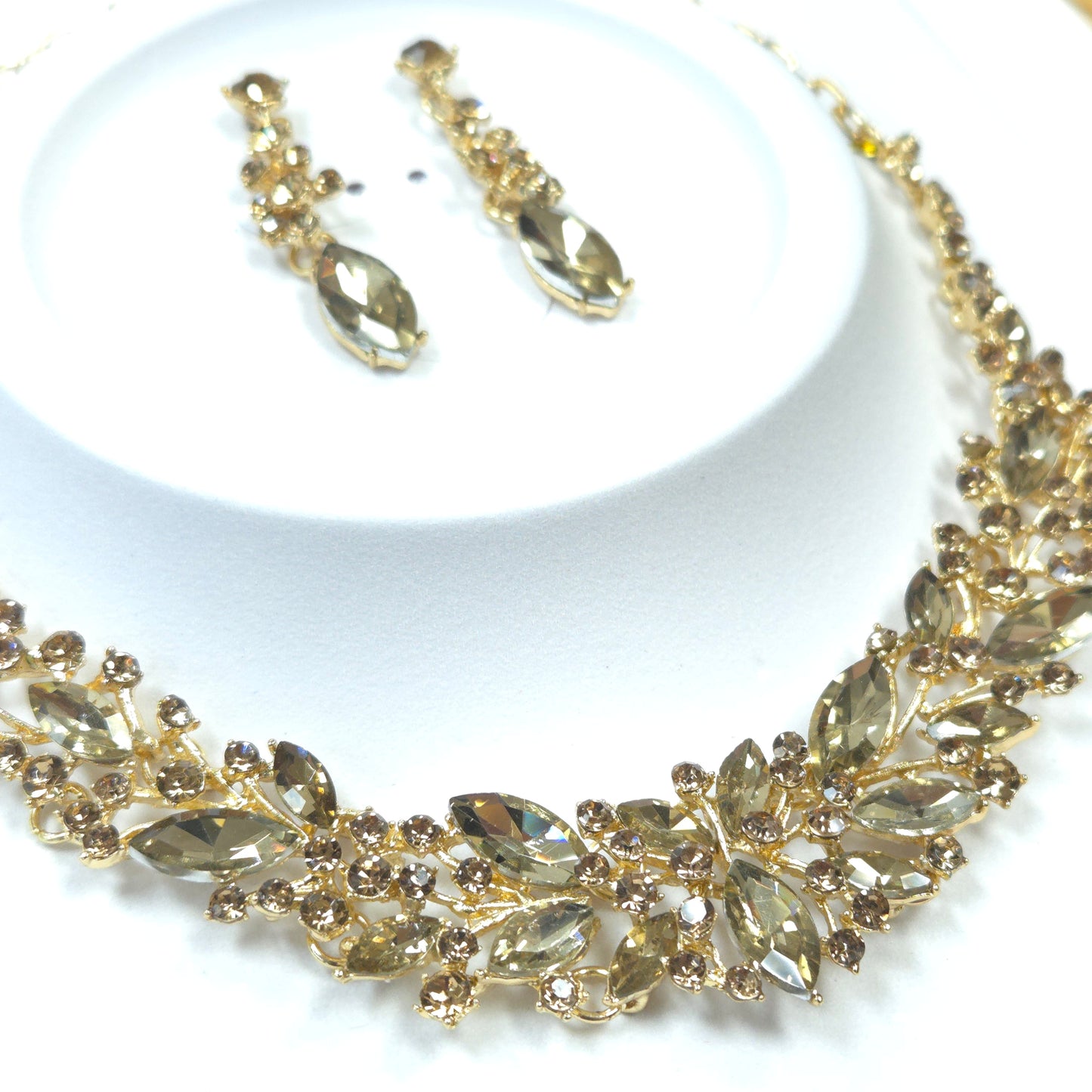 Gold headband and earrings set on a white background