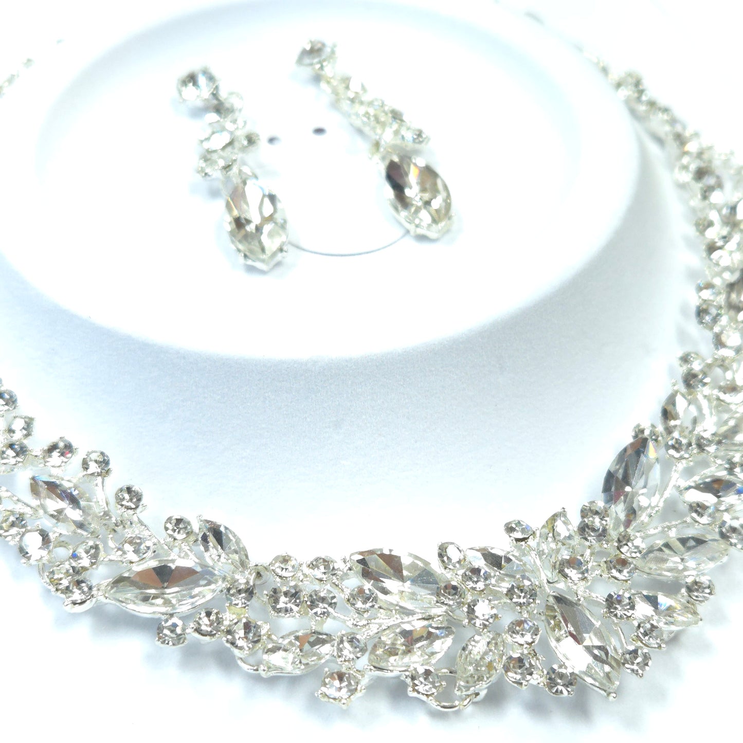 Close-up of a decorative silver chain with intricate design on a white background