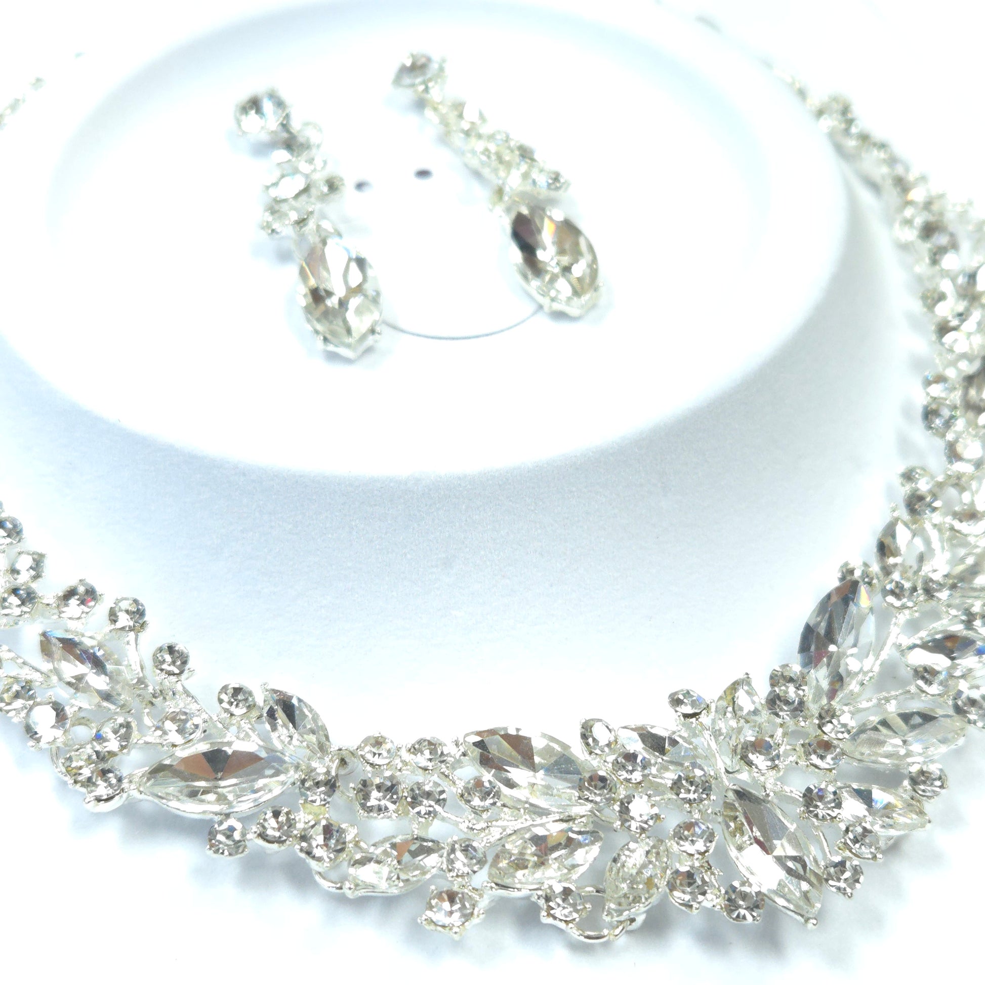Close-up of a decorative silver chain with intricate design on a white background