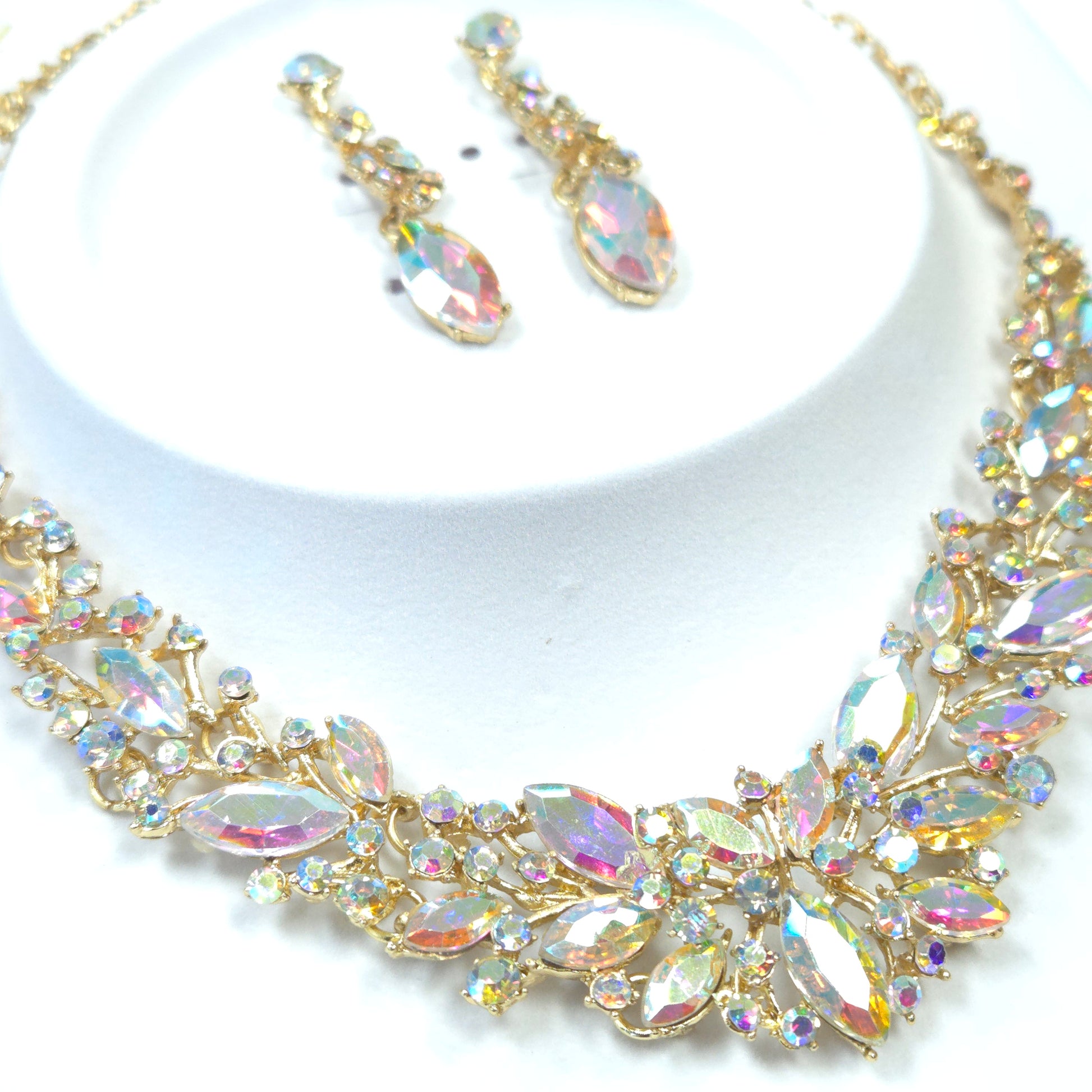 Gold jewelry set with crystals on a white background