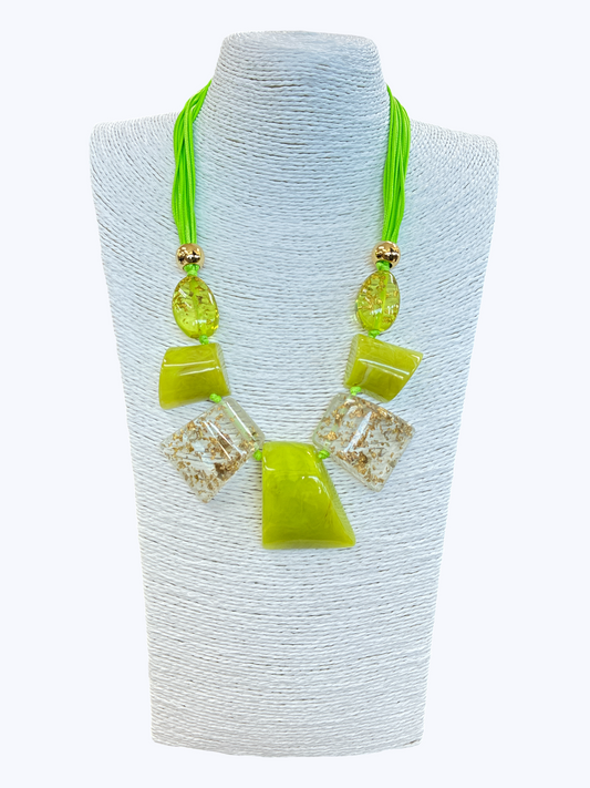 Neon green statement necklace with glossy geometric resin accents, gold fleck details, and layered cord strands for a bold contemporary boutique look.
