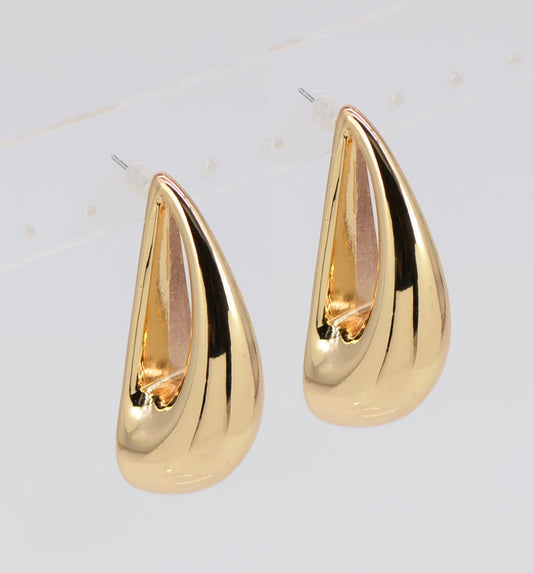 Gold teardrop earrings on a light gray background