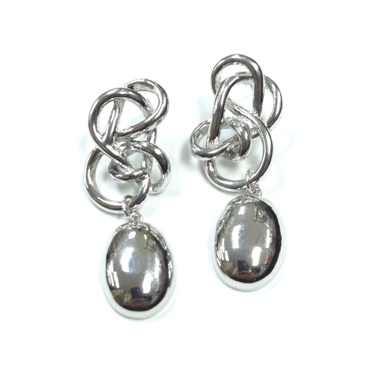 Pair of silver earrings with interlocking design and oval drops on a white background