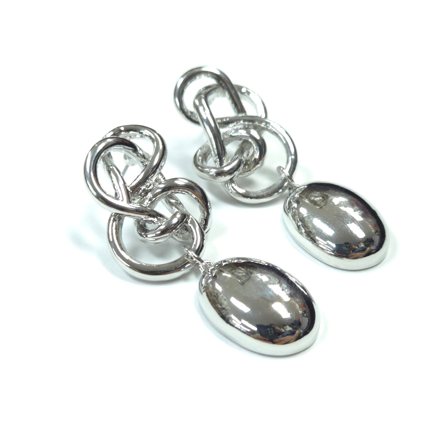 Pair of silver earrings with teardrop-shaped stones on a white background