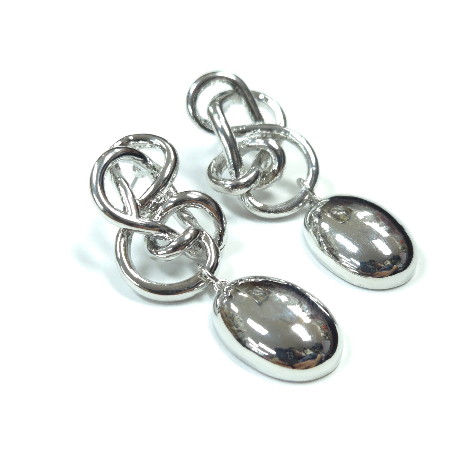 Pair of silver earrings with teardrop-shaped stones on a white background