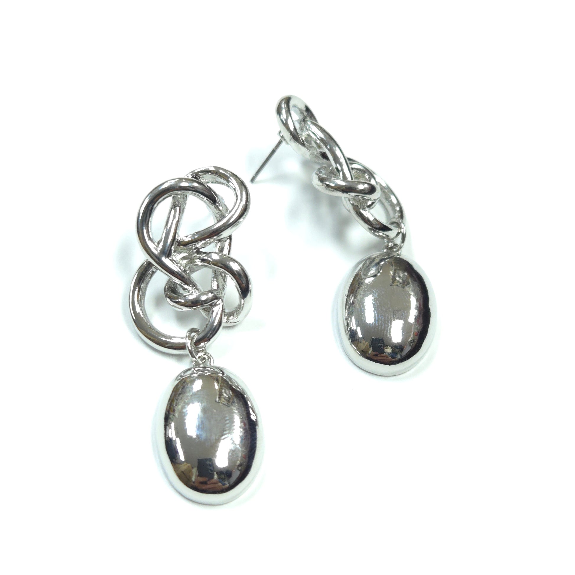 Pair of silver earrings with circular and interlocking design on a white background