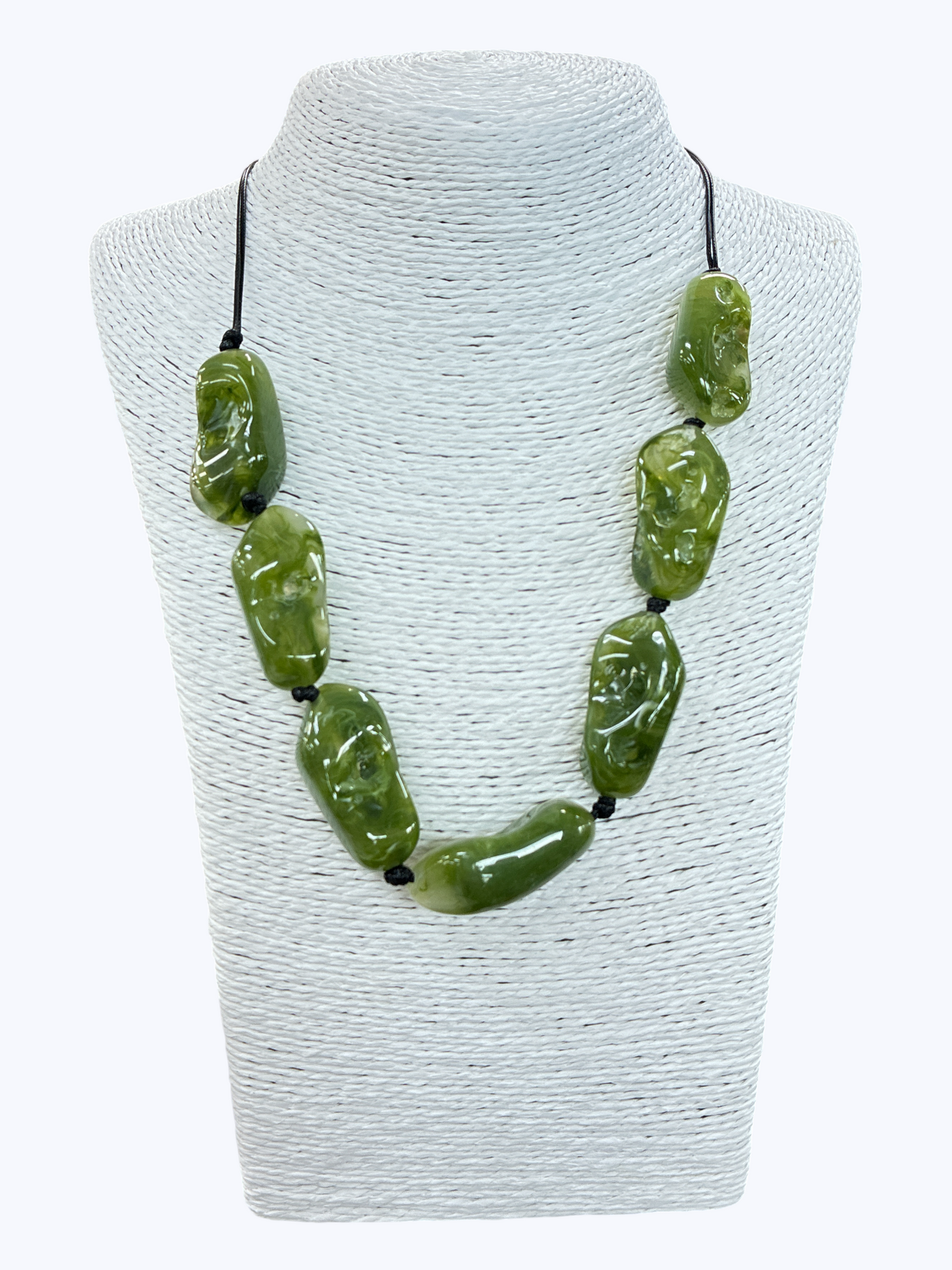 Olive green textured bead necklace with glossy organic-shaped beads and minimalist black cord on display bust