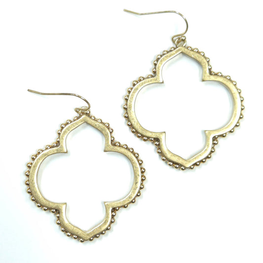 Gold quatrefoil earrings on a white background