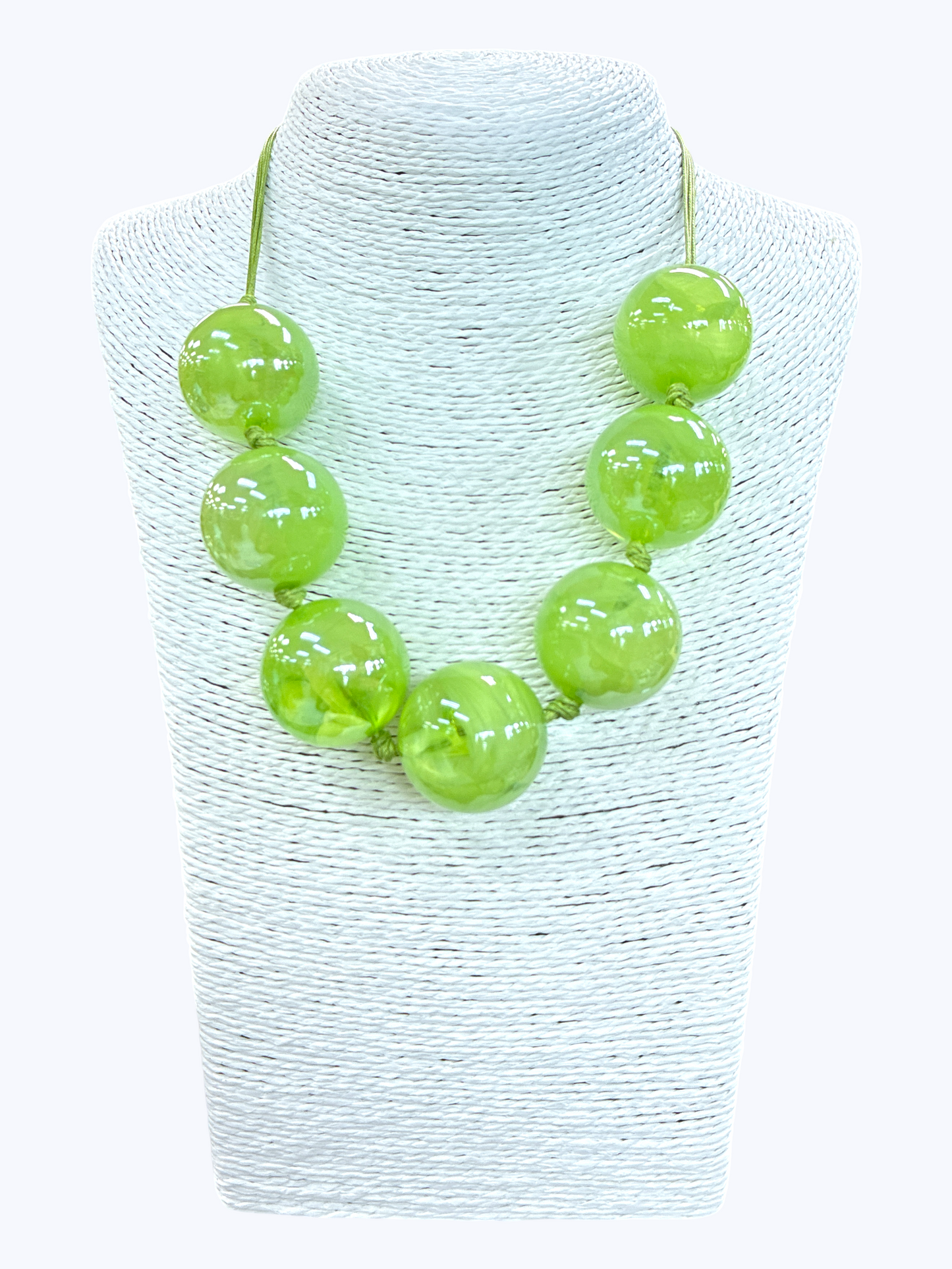 Lime green chunky bead statement necklace with glossy oversized beads and minimalist cord design displayed on mannequin bust