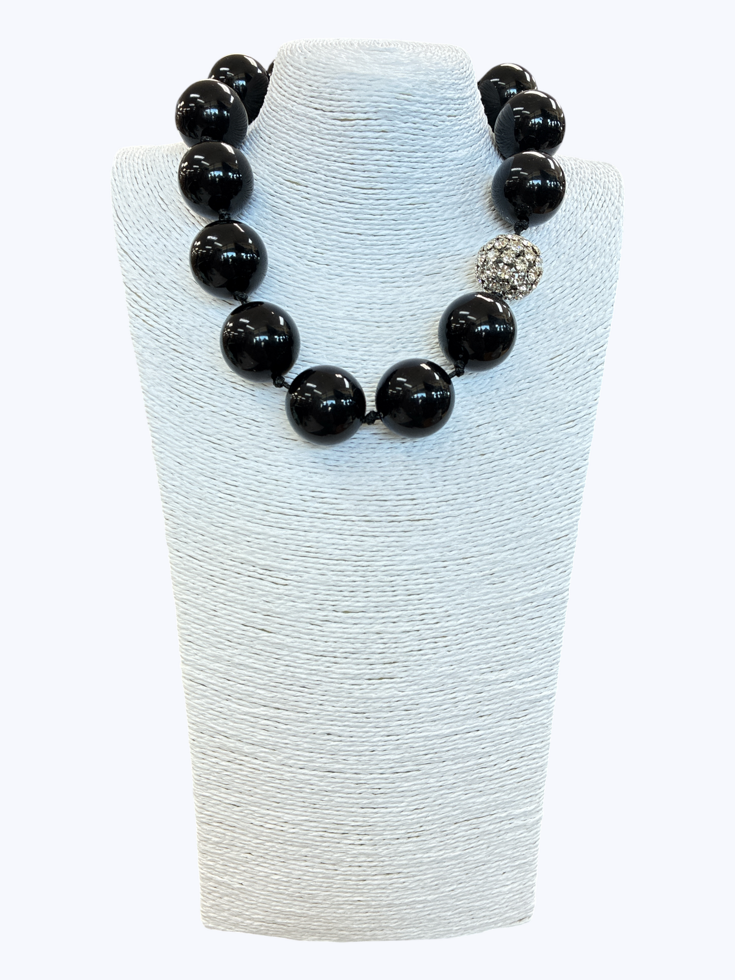 Chunky black bead statement necklace with oversized glossy round beads and a sparkling rhinestone accent for a bold boutique glam look.