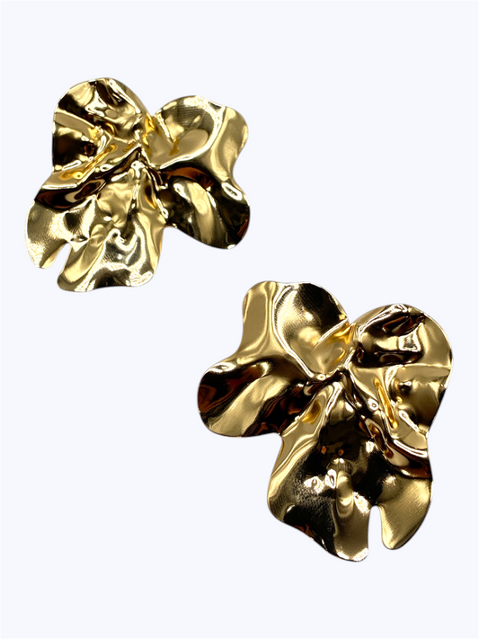 Pair of gold floral earrings on a white background