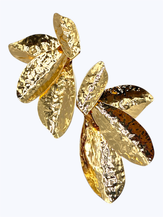 Hammered leaf drop earrings with layered botanical shapes and textured organic metal finish.