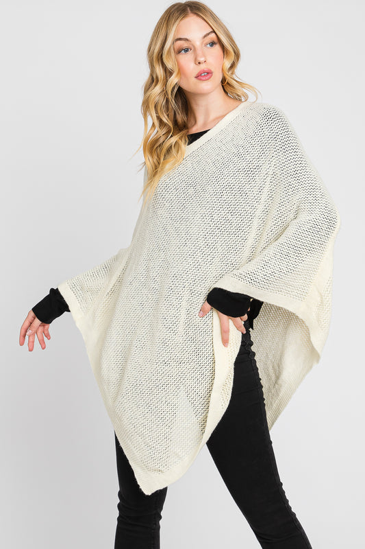 Woman wearing a cream-colored poncho against a white background