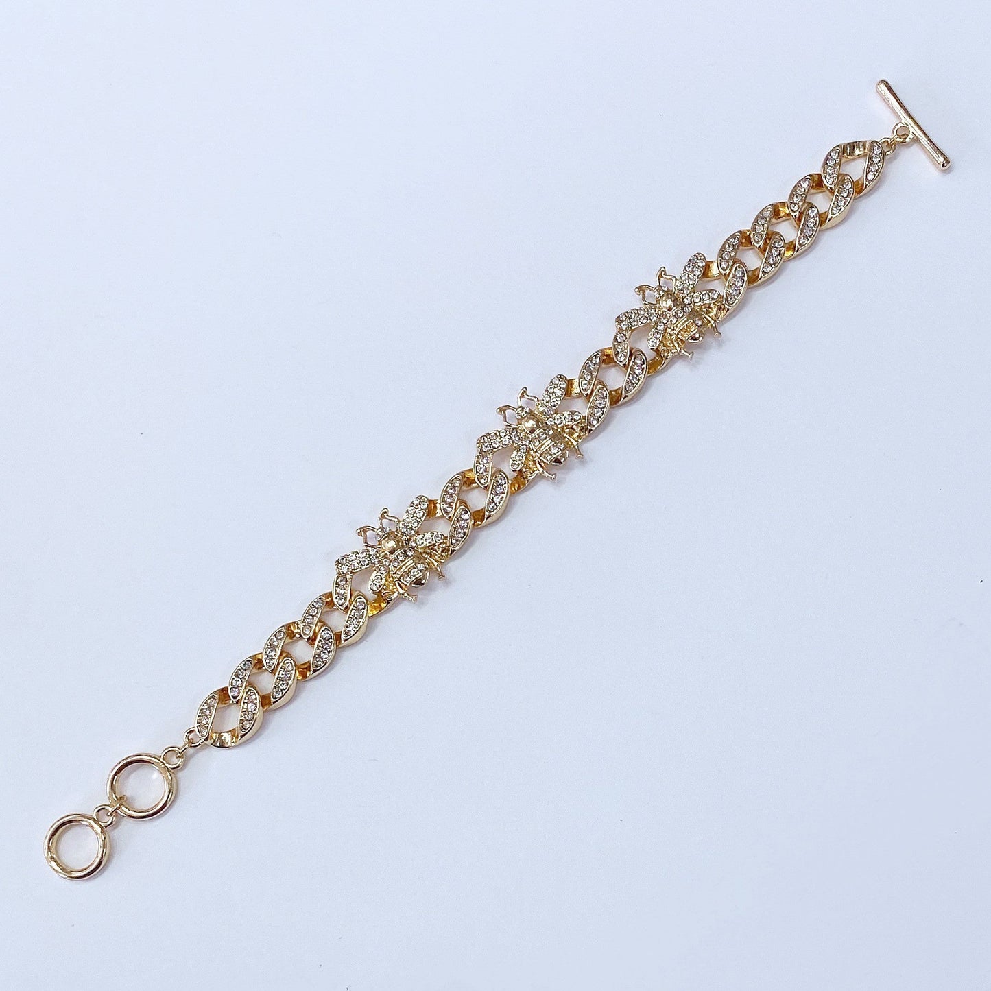 Chunky chain bracelet featuring crystal bee motifs, pavé links, and toggle clasp closure