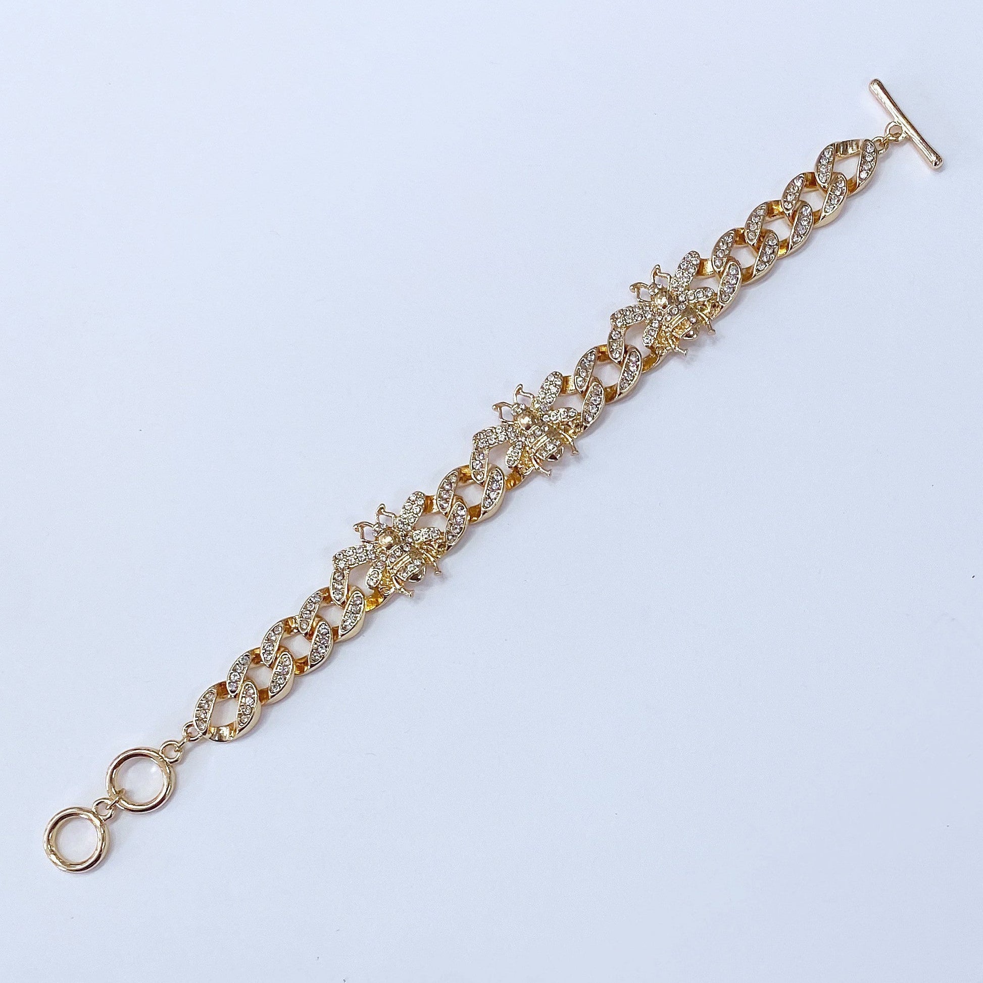 Chunky chain bracelet featuring crystal bee motifs, pavé links, and toggle clasp closure