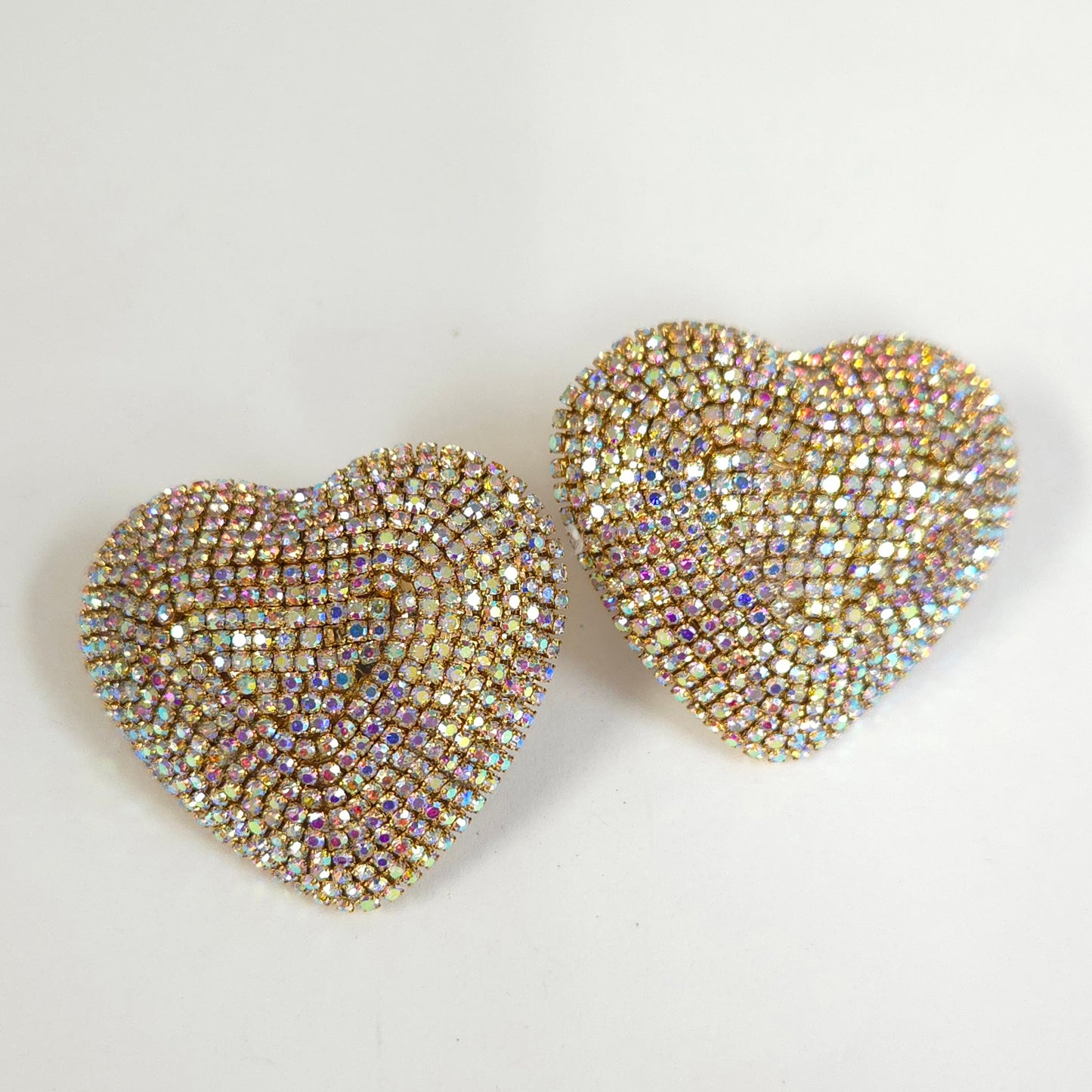 Heart-shaped earrings with rhinestone embellishments on a light background