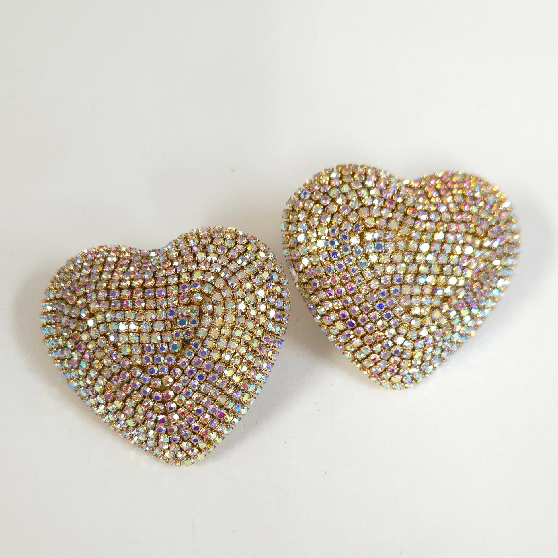 Heart-shaped earrings with rhinestone embellishments on a light background