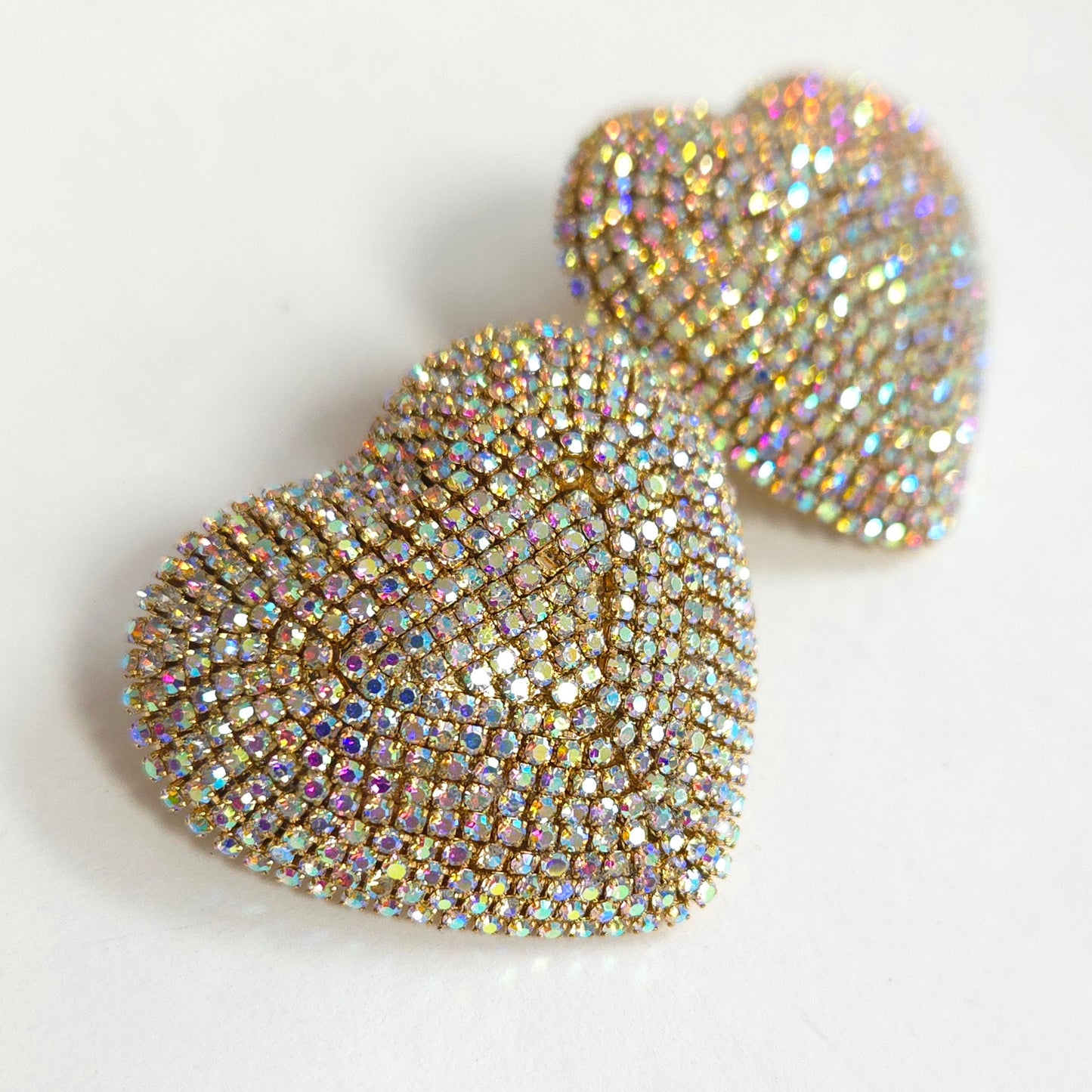 Heart-shaped earrings with rhinestone embellishments on a light background