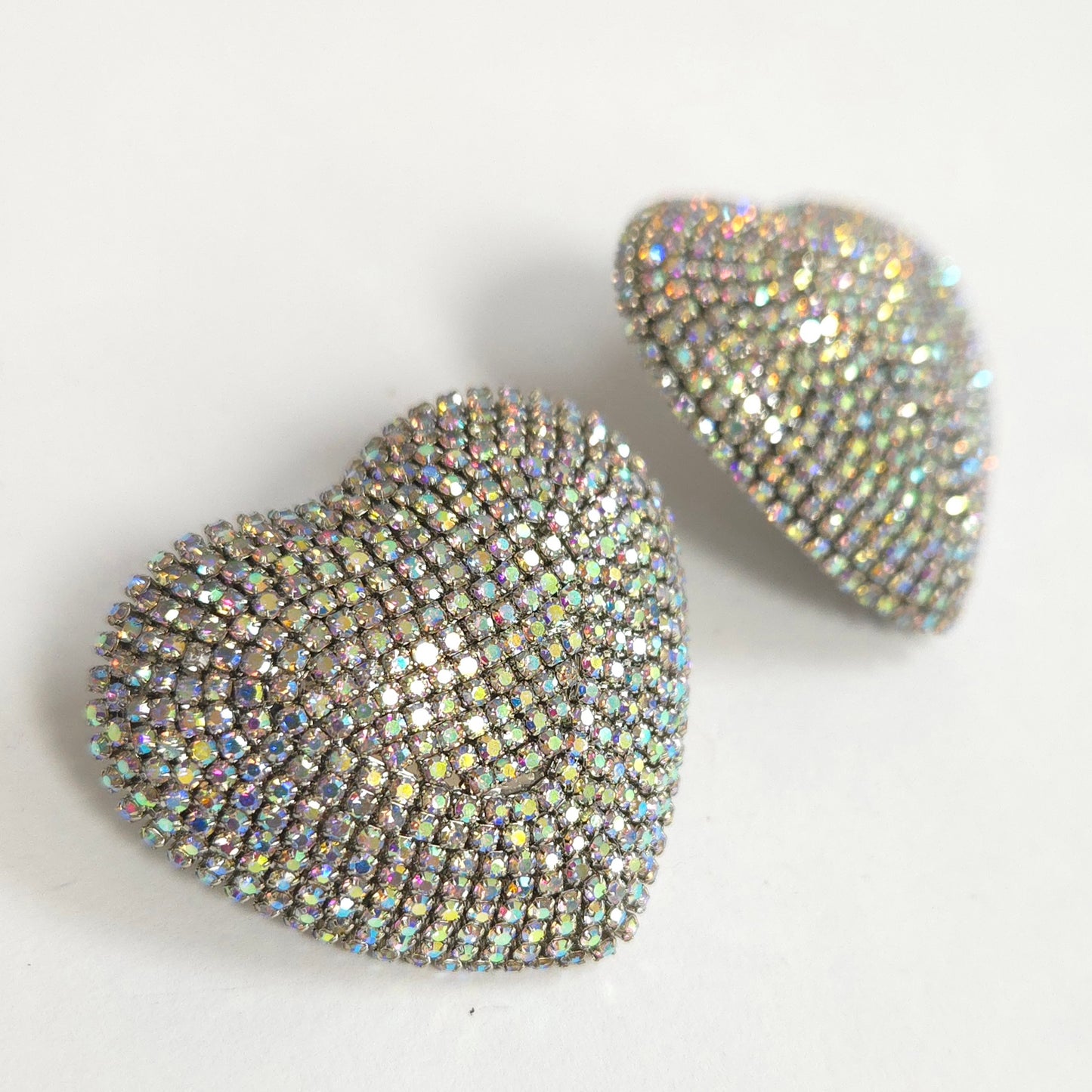 Heart-shaped earrings with rhinestone embellishments on a light background