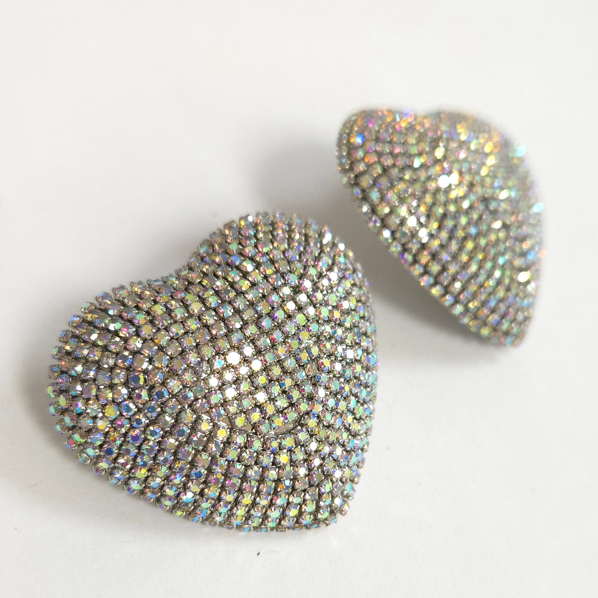Heart-shaped earrings with rhinestone embellishments on a light background