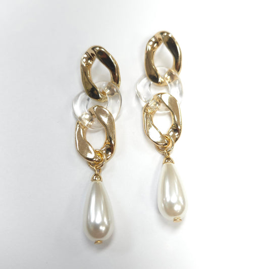 Gold chain earrings with pearl drops on a white background