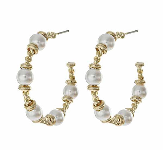 Gold hoop earrings with pearl beads on a white background