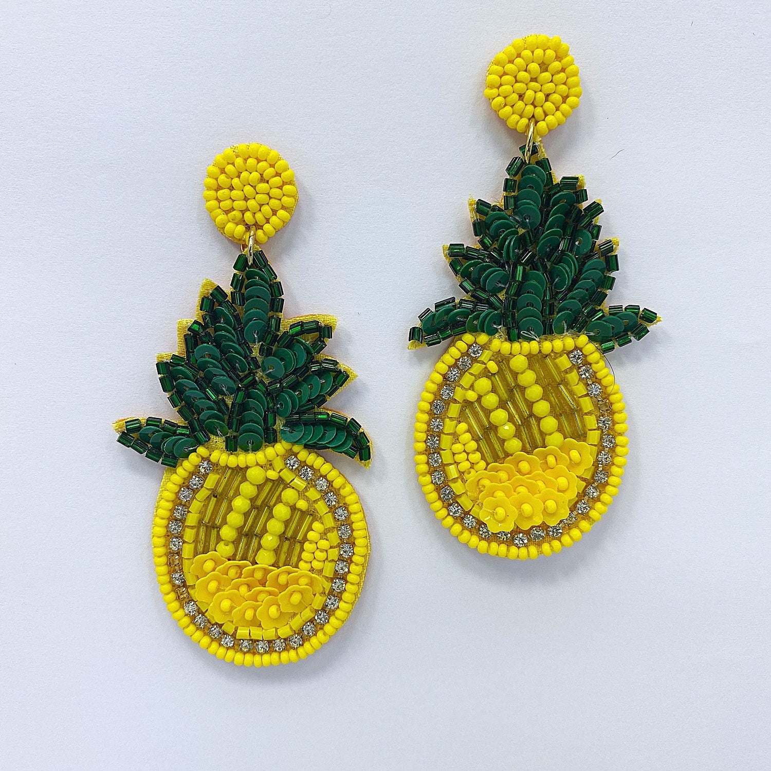 A pair of yellow and green beaded dangle earrings designed to resemble a pineapple.