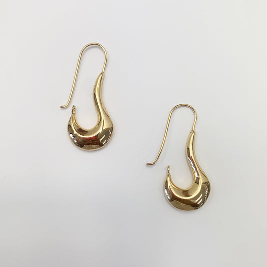 A pair of gold-colored earrings designed in a Bohemian style with a safety pin attachment.