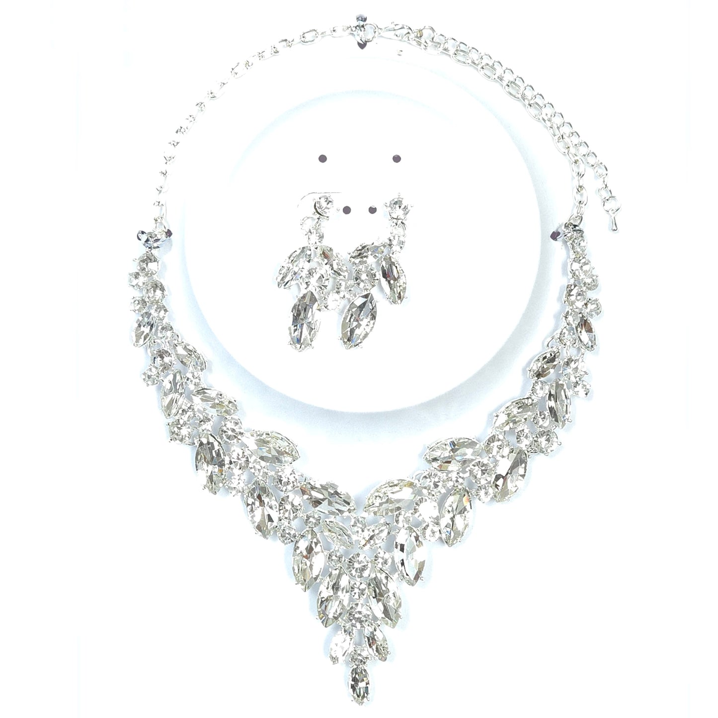 Silver necklace and earrings set on a white background