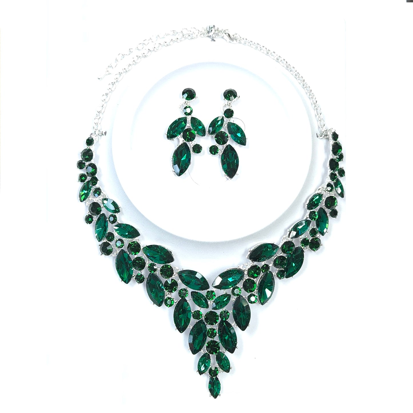 Jewelry set with green gemstones on a white background