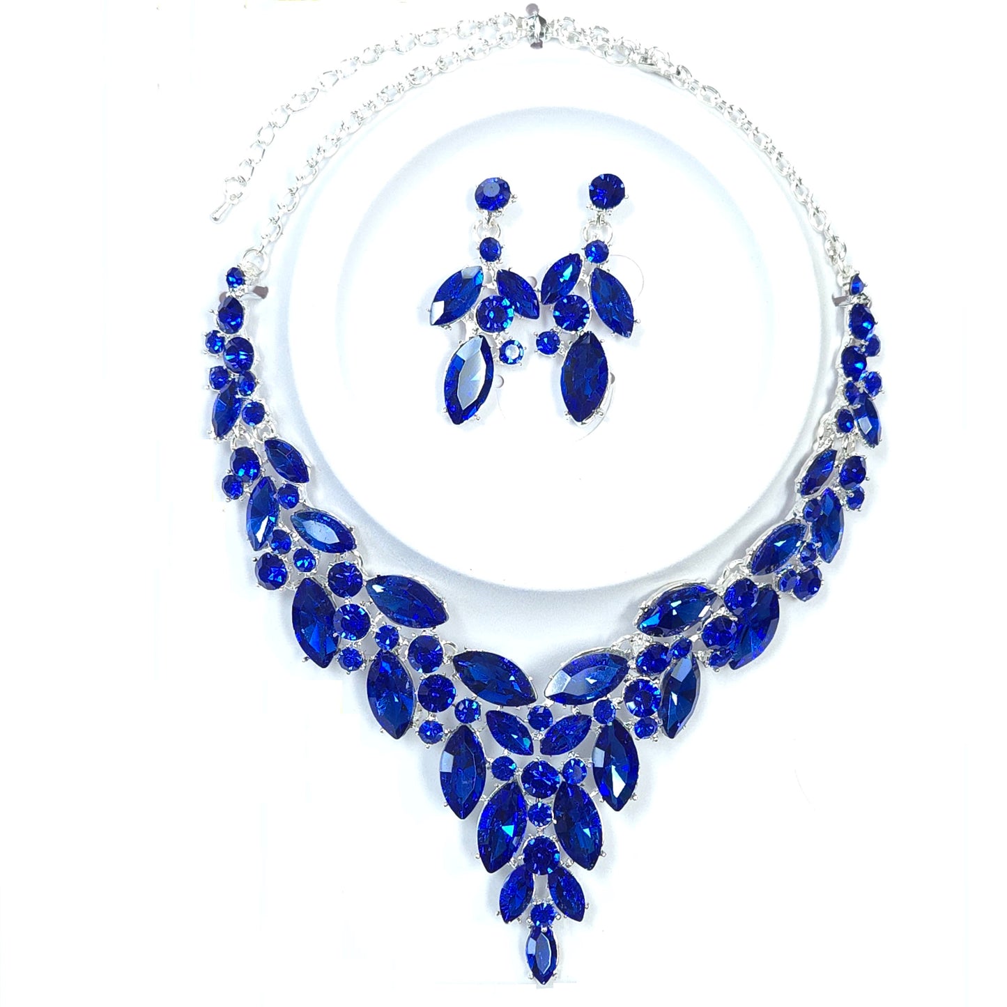 Jewelry set with blue gemstones on a white background