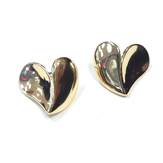 Heart-shaped gold earrings on a white background