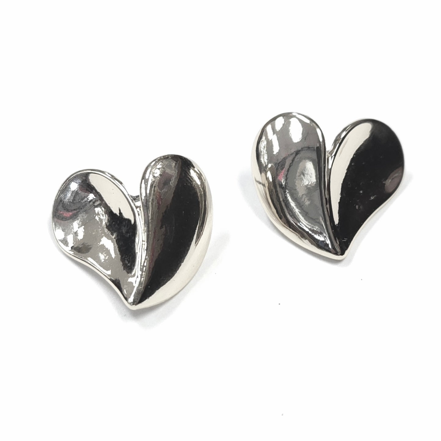 Heart-shaped silver earrings on a white background