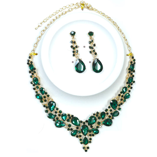 Necklace and earrings set with green gemstones on a white background