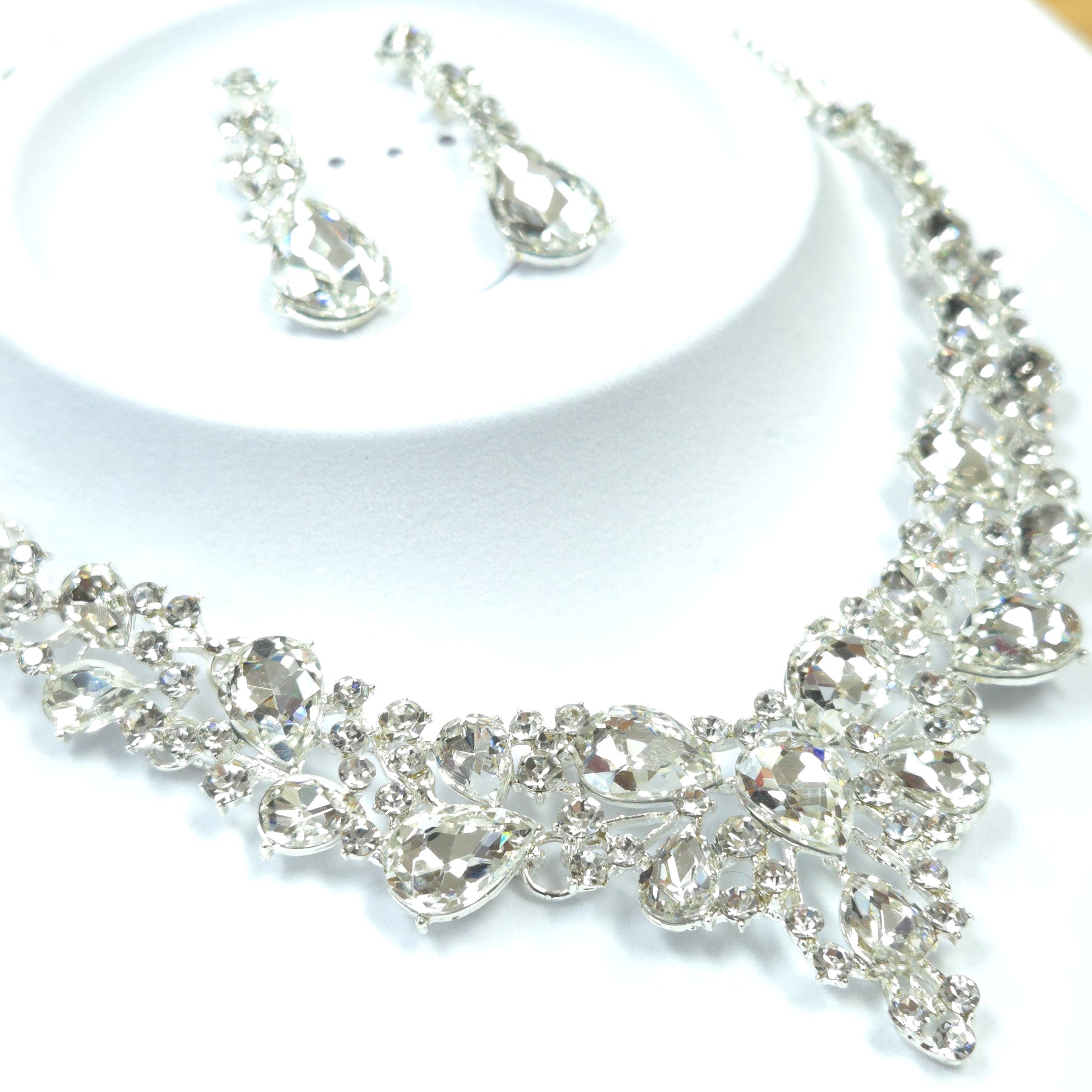 Silver bracelet and earrings on a white background