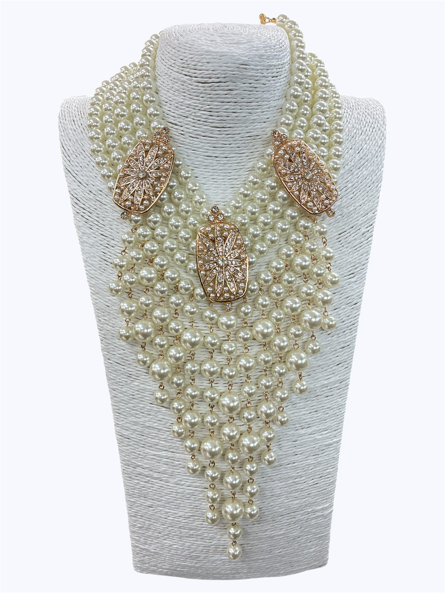 Layered faux pearl statement necklace featuring cascading pearl fringe strands with rhinestone geometric accents and dramatic bib styling.