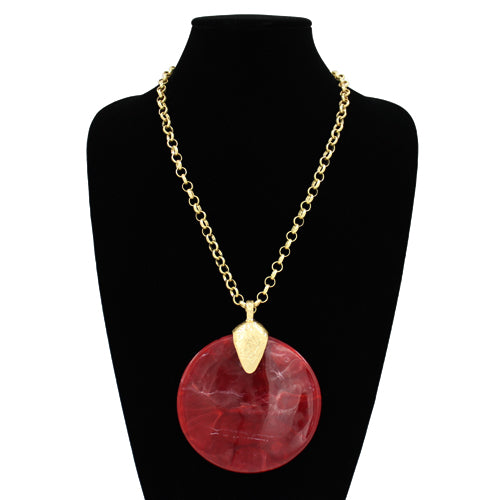 Oversized round resin pendant necklace with a textured disc charm on a link chain.