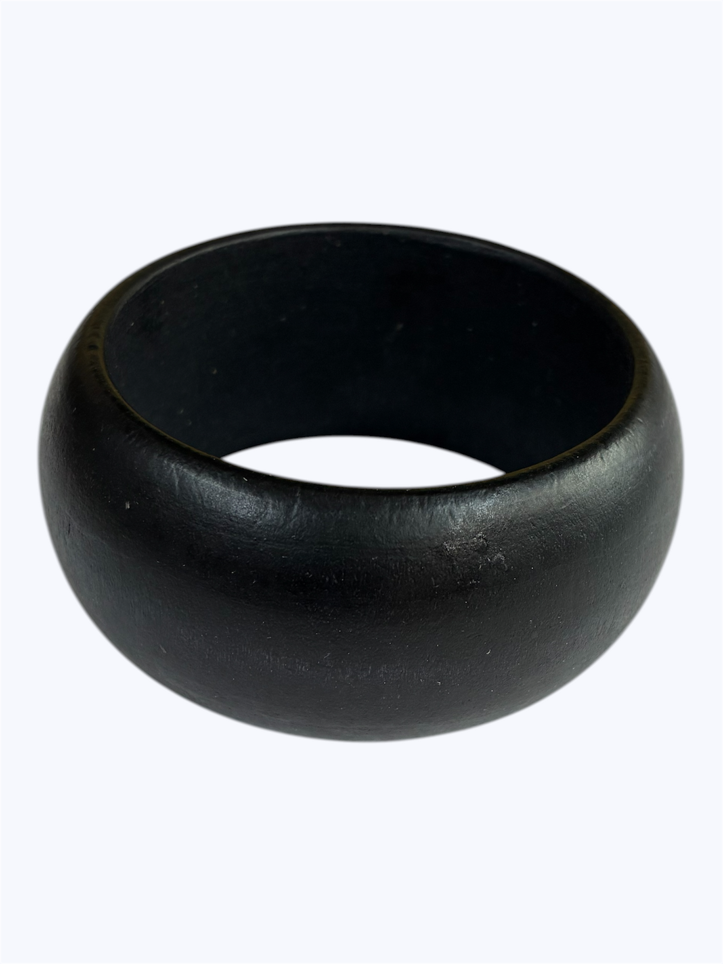 Black rounded bangle bracelet with a sleek minimalist silhouette and smooth polished finish