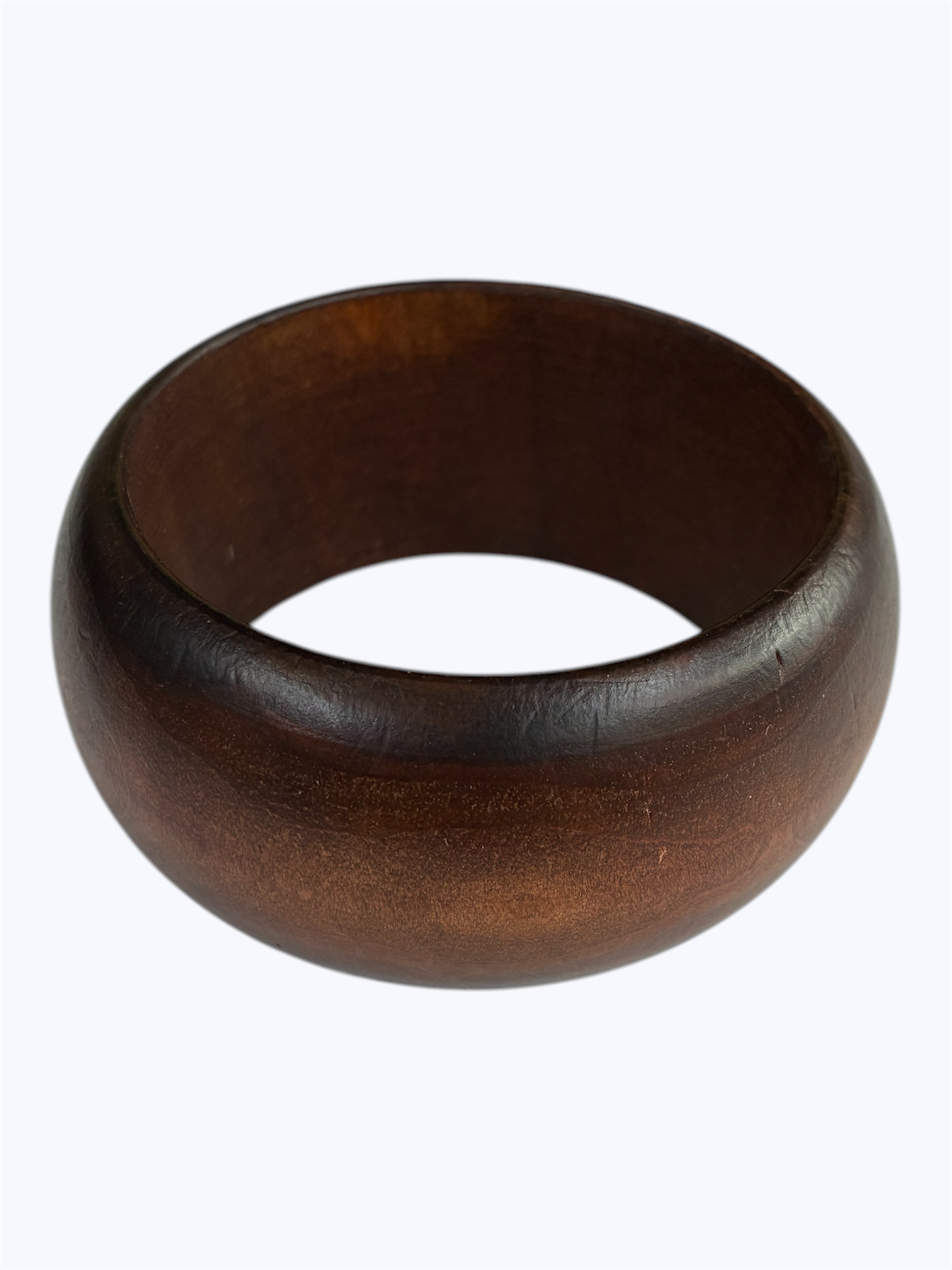 Brown rounded bangle bracelet with a smooth minimalist silhouette and polished finish